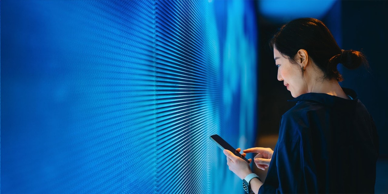 Woman looking at data points on screen