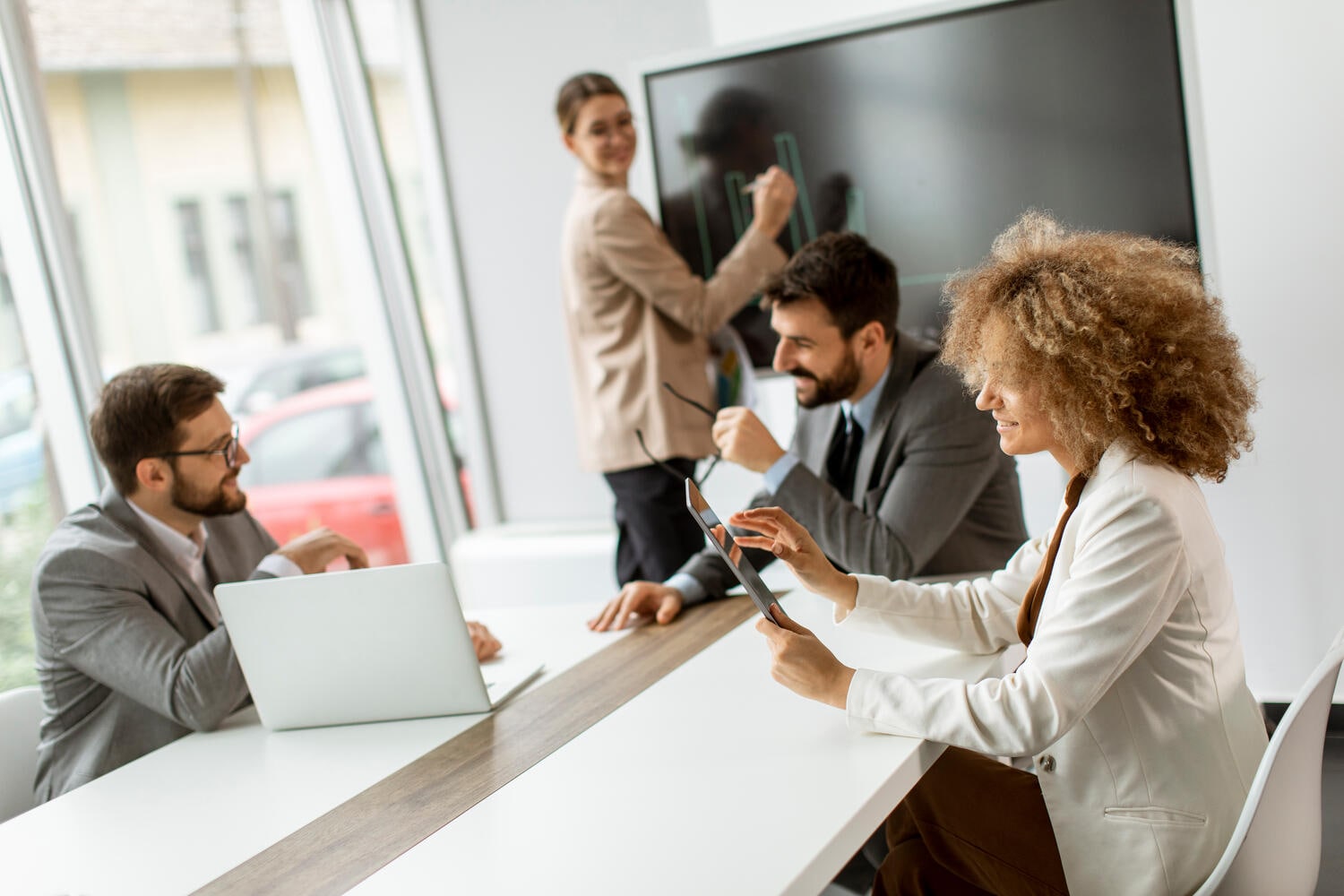 A group of people, out of focus, working together in the office
